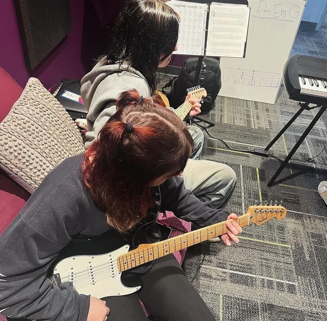 Students playing music in the music studio